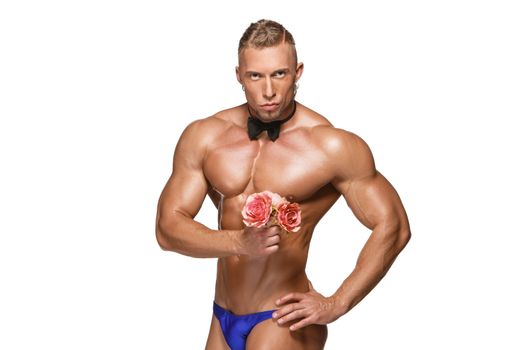 the very muscular handsome sexy guy  with butterfly and flowers on white background, naked  torso. the concept of a ladies' man