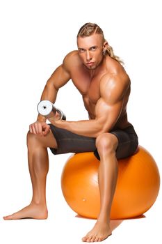 Shaped and healthy body man  sitting on fitness ball isolated on white background