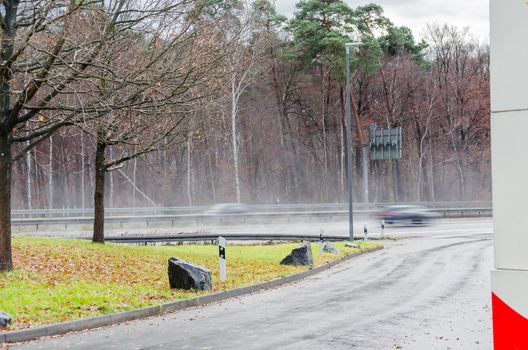 View of a parking lot on a highway in heavy rain.