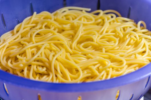 Noodles in a colander under cold water after the scare.