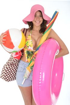 Young Attractive Woman Wearing a Swim Suit on Holiday Carrying a Beach Ball Rubber Ring and Parasol