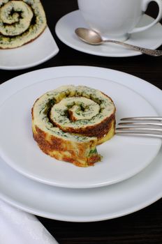 slice of omelette with herbs and a cup of black coffee on the table