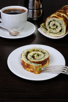 slice of omelette with herbs and a cup of black coffee on the table