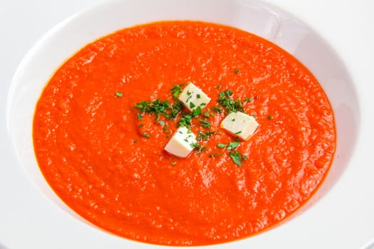 Tomato soup with herbs and cheese isolated on white backgraund