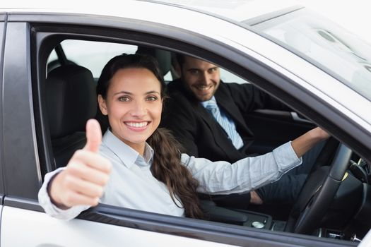 Business team smiling and driving in the car