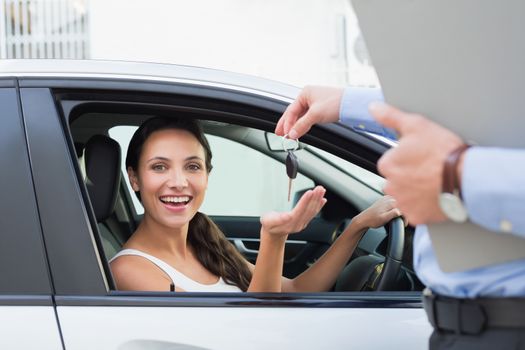 Young woman getting her key in the car