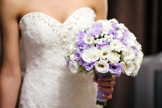 Bride holding a bouquet of roses