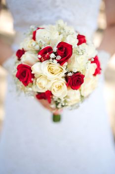 Bride holding a bouquet of roses