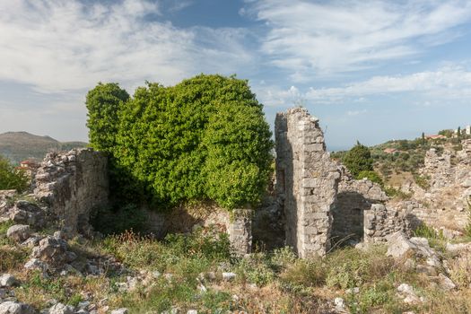 The high fortress walls with the scenic mountains on the background, Stari Bar, Montenegro.