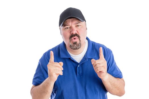 Perplexed man pointing upwards with his fingers as he frowns at the camera with a puzzled quizzical expression requiring an explanation, isolated on white