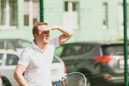 young man play tennis outdoor on tennis field at early morning