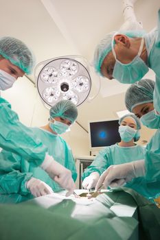 Medical students practicing surgery on model at the university