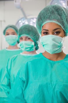 Medical students in operating theater looking at camera at the university