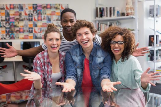 Fashion students smiling at camera together at the college