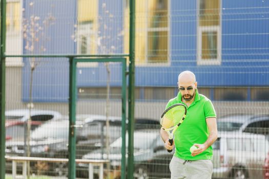 young man play tennis outdoor on tennis field at early morning