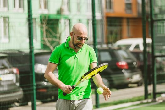 young man play tennis outdoor on tennis field at early morning