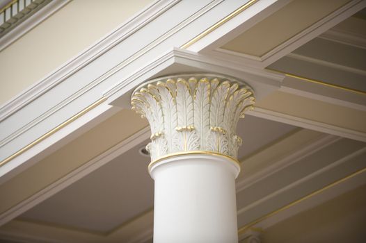 Image of the cornice of a corinthian column with gold leafing