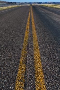 Image of the double yellow lines on a rural road from low angle