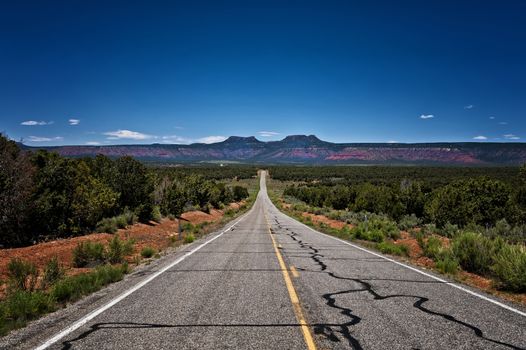 Image of a long desolate road leading off into a plateau