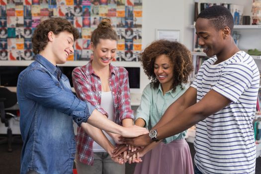 Fashion students putting hands together at the college