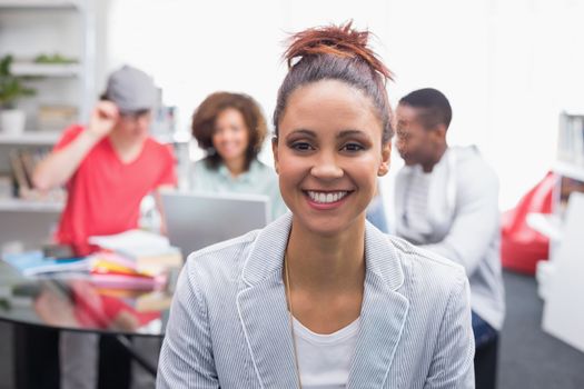 Fashion student smiling at camera at the college