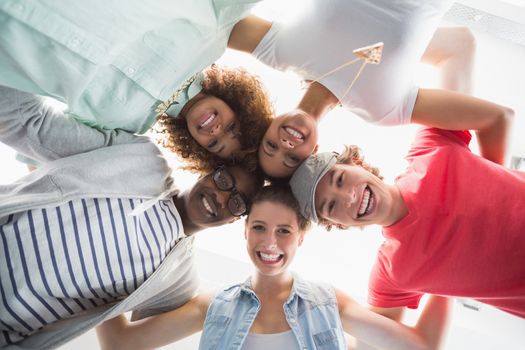 Fashion students smiling at camera together at the college