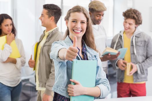 Fashion student smiling at camera at the college