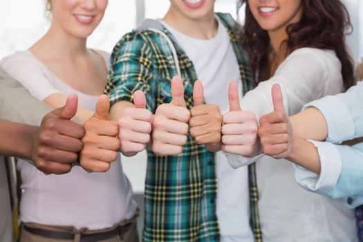 Fashion students showing thumbs up at the college