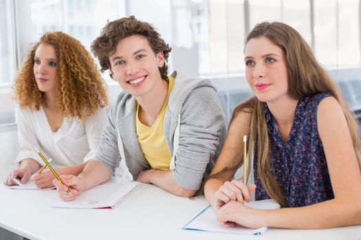 Fashion student smiling at camera at the college