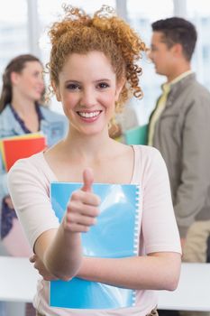 Fashion student smiling at camera at the college