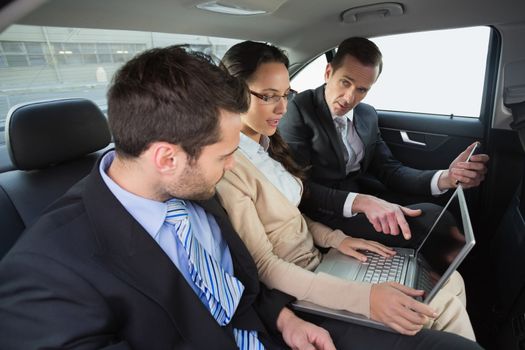 Business team working in the back seat in the car