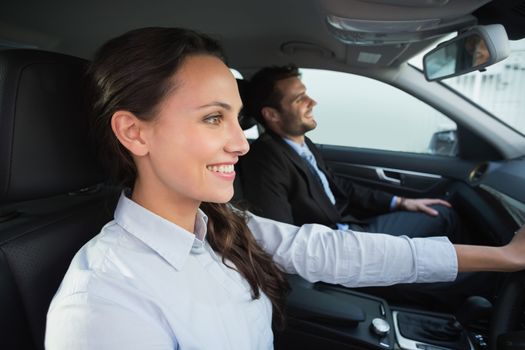 Business team smiling and driving in the car