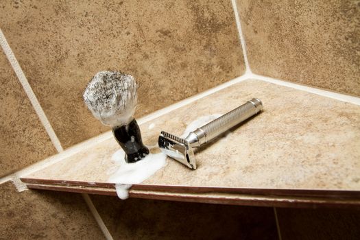 Old fasion safety razor and shaving brush in the bathroom