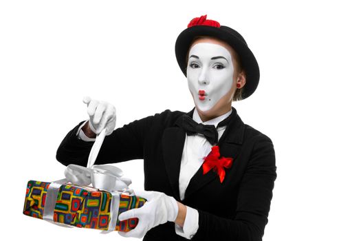 Mime as playful, joyful and excited woman with gift standing isolated on white background. 