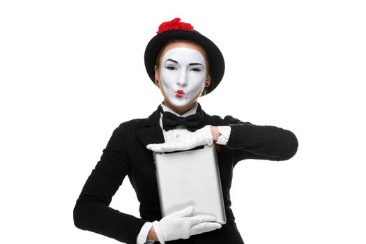 business woman in the image mime holding tablet PC and demonstrating anything. isolated on white background