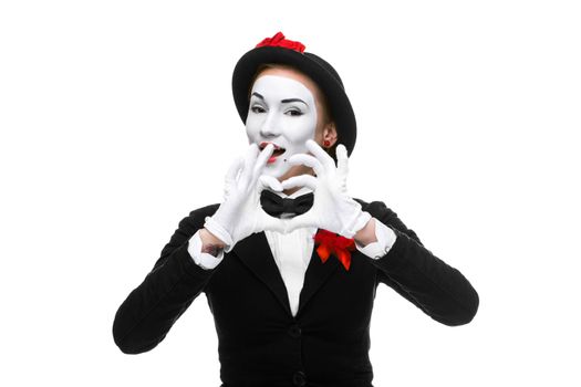 Portrait of the woman as mime with hands folded in the shape of a heart isolated on white background. Concept of love