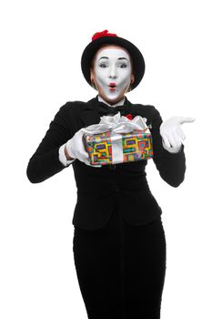 Mime as playful, joyful and excited woman with gift standing isolated on white background. 