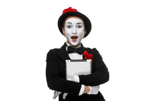 surprised mime with tablet PC in  her hands isolated on white  background