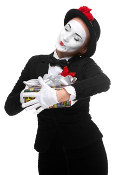 Mime as playful, joyful and excited woman with gift standing isolated on white background. 