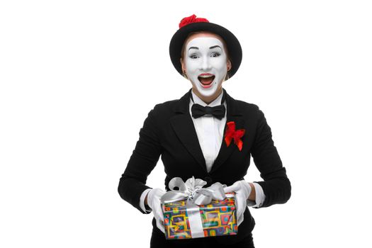 Mime as playful, joyful and excited woman with gift standing isolated on white background. 