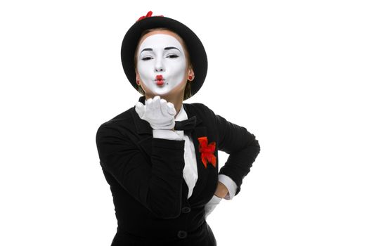 Portrait of the woman as mime sending a kiss isolated on white background. Concept of love