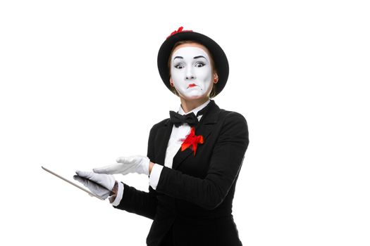 surprised business woman in the image mime holding tablet PC isolated on white background