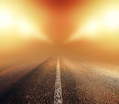 empty asphalt road in heavy fog at night