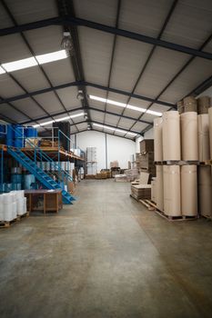 Close up of many containers in a large warehouse