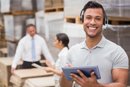 Female manager using digital tablet in warehouse 