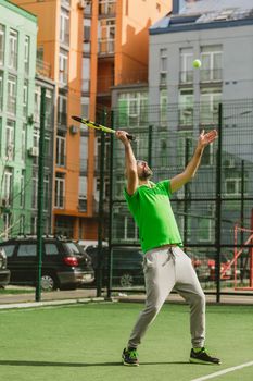 young man play tennis outdoor on tennis field at early morning