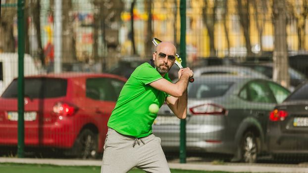 young man play tennis outdoor on tennis field at early morning