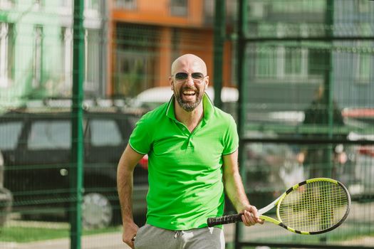 young man play tennis outdoor on tennis field at early morning