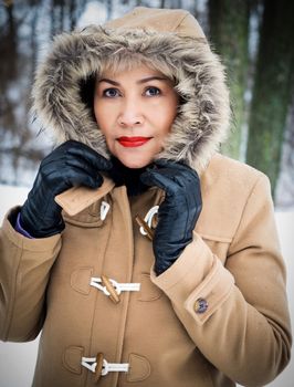 Asian model in the snow with fur coat