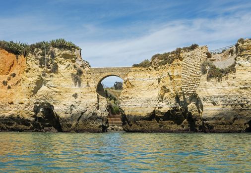 rocks and cliff with stairs and bridge in algarve city lagos in Portugal, the most beautifull coastline of the world